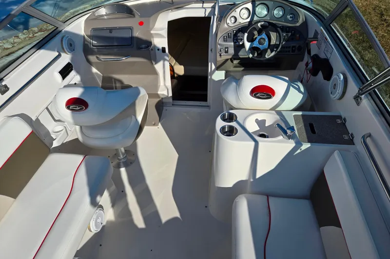 Slide: The Image of 2007 Rinker 262 Captiva Cuddy boat interior with steering wheel, seating, and control panel. - 12
