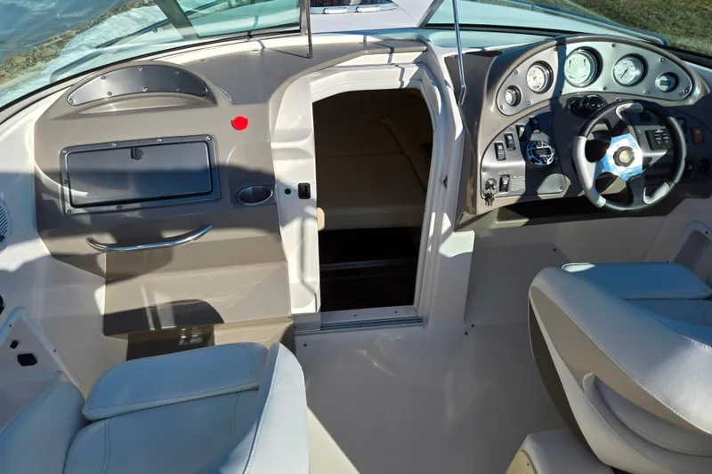 Slide: The Image of 2007 Rinker 262 Captiva Cuddy boat interior with steering wheel and dashboard controls. - 13