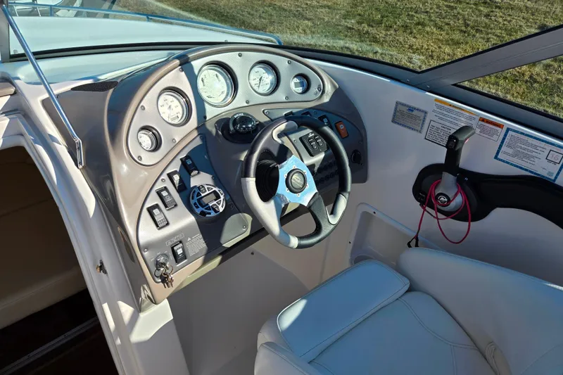 Slide: The Image of 2007 Rinker 262 Captiva Cuddy boat dashboard with steering wheel and control panel. - 15