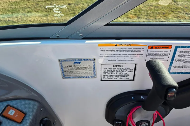 Slide: The Image of 2007 Rinker 262 Captiva Cuddy dashboard with yacht certification and safety warnings. - 16