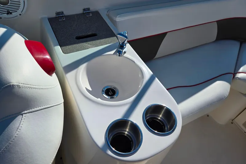 Slide: The Image of 2007 Rinker 262 Captiva Cuddy boat interior with sink and cup holders. - 17