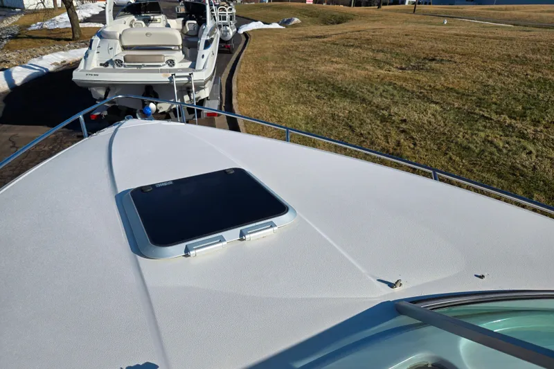 Slide: The Image of 2007 Rinker 262 Captiva Cuddy boat on trailer, parked on grassy area. - 18