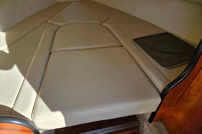 Slide: The Image of 2007 Rinker 262 Captiva Cuddy cabin interior with beige upholstery. - 19