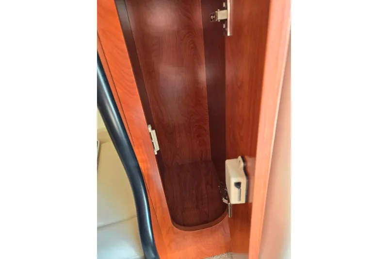 Slide: The Image of 2007 Rinker 262 Captiva Cuddy interior wooden storage compartment. - 21