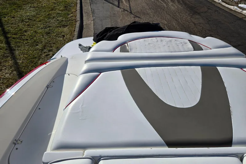 Slide: The Image of 2007 Rinker 262 Captiva Cuddy boat with white and gray seating on a sunny day. - 26