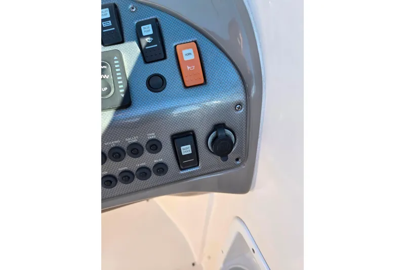 Slide: The Image of Control panel of 2007 Rinker 262 Captiva Cuddy boat with switches and buttons. - 27