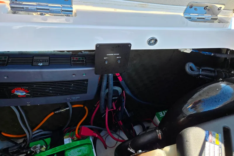 Slide: The Image of 2007 Rinker 262 Captiva Cuddy engine compartment with wiring and battery system. - 30