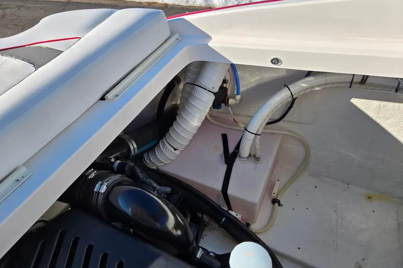 Slide: The Image of Engine compartment of a 2007 Rinker 262 Captiva Cuddy boat, showing hoses and components. - 31