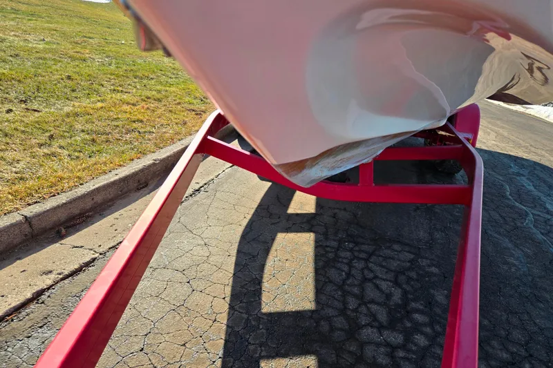 Slide: The Image of 2007 Rinker 262 Captiva Cuddy on red trailer, showing hull and pavement. - 7