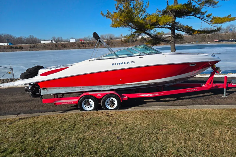 Slide: The Image of 2007 Rinker 262 Captiva Cuddy boat on trailer by a frozen lake. - 9