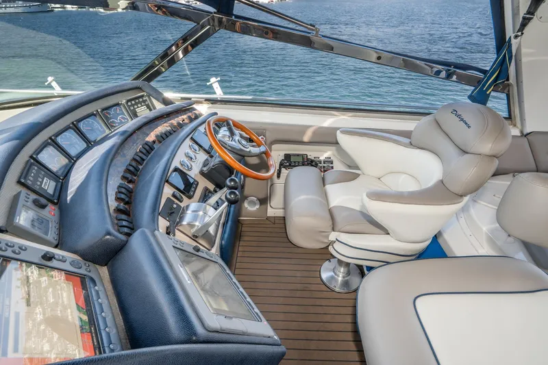 Slide: The Image of Cockpit of 1999 Sea Ray 500 Sundancer with luxurious seating and advanced navigation controls. - 10