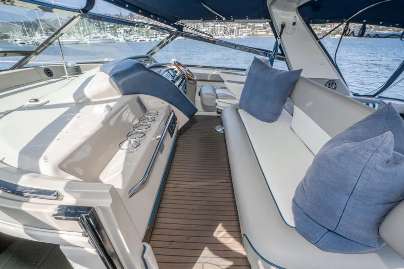 Slide: The Image of Luxurious interior of a 1999 Sea Ray 500 Sundancer yacht with plush seating and scenic marina view. - 16