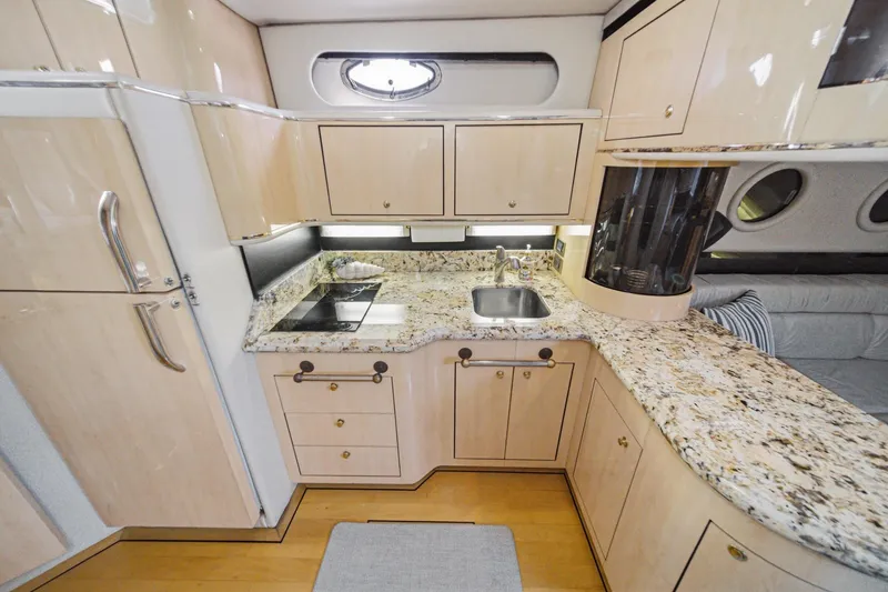 Slide: The Image of Luxurious 1999 Sea Ray 500 Sundancer yacht kitchen with granite countertops and modern cabinetry. - 20