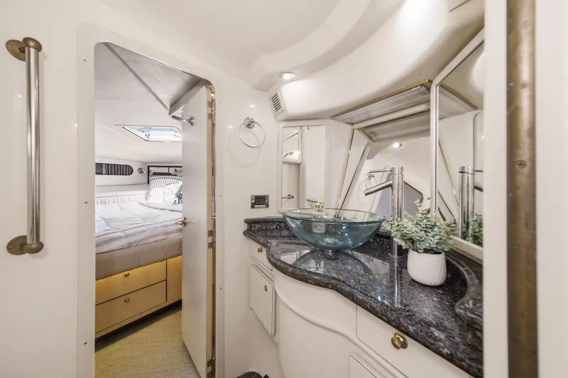 Slide: The Image of Luxurious 1999 Sea Ray 500 Sundancer yacht interior with modern bathroom and cozy bedroom. - 23