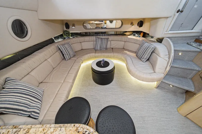Slide: The Image of Luxurious interior of 1999 Sea Ray 500 Sundancer yacht with plush seating and ambient lighting. - 24
