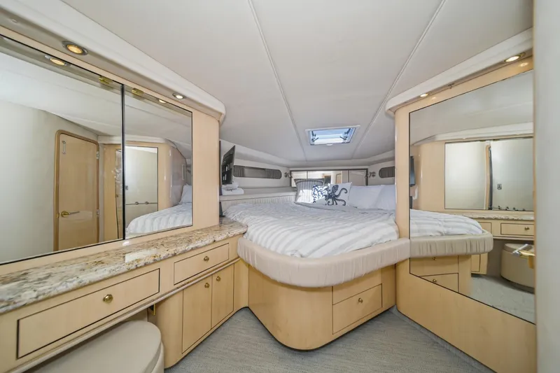 Slide: The Image of Luxurious 1999 Sea Ray 500 Sundancer yacht bedroom with elegant decor and ample storage. - 25