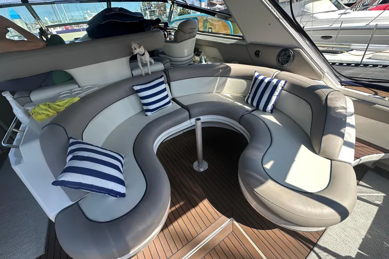 Slide: The Image of Luxurious 1999 Sea Ray 500 Sundancer interior with curved seating and striped cushions. - 3