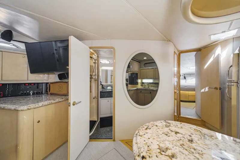 Slide: The Image of Interior of 1999 Sea Ray 500 Sundancer yacht with modern kitchen and luxurious design. - 30