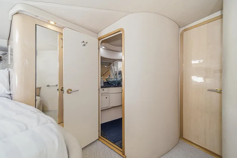 Slide: The Image of Interior of 1999 Sea Ray 500 Sundancer yacht, featuring bedroom and bathroom doors. - 31