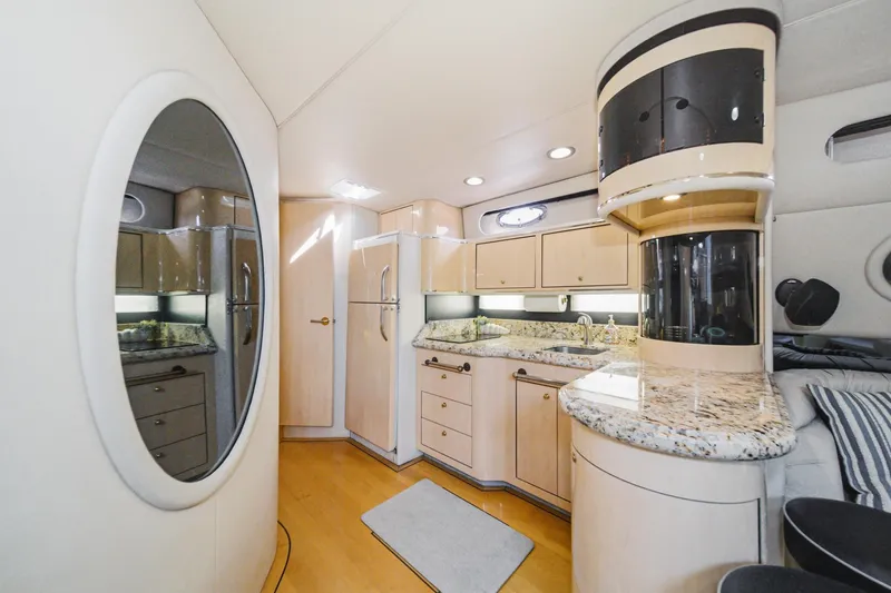 Slide: The Image of Luxurious interior of a 1999 Sea Ray 500 Sundancer yacht with modern kitchen amenities. - 32