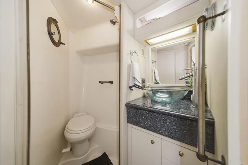 Slide: The Image of Bathroom interior of 1999 Sea Ray 500 Sundancer yacht with modern sink and toilet. - 33