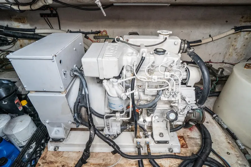 Slide: The Image of Engine room of 1999 Sea Ray 500 Sundancer with visible machinery and wiring. - 35