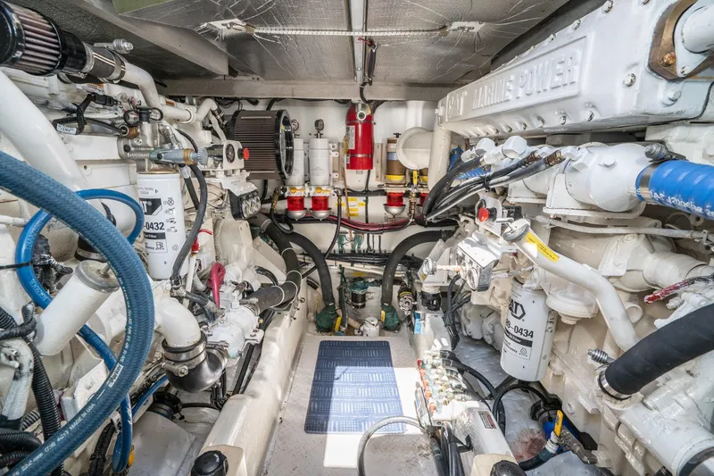 Slide: The Image of Engine room of a 1999 Sea Ray 500 Sundancer, showcasing complex machinery and components. - 38