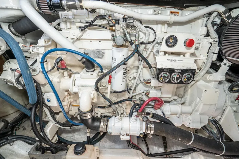Slide: The Image of Engine compartment of a 1999 Sea Ray 500 Sundancer boat, showcasing detailed components. - 39