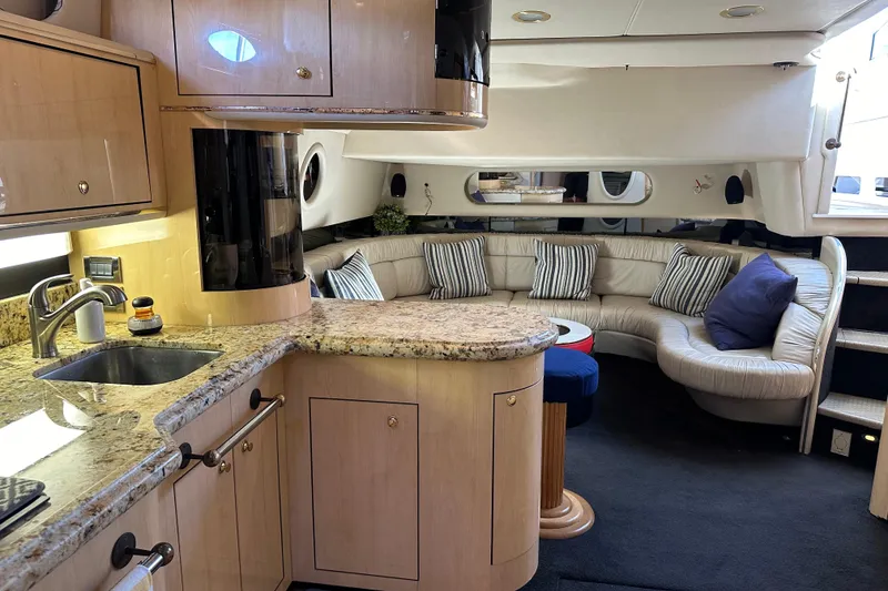Slide: The Image of Luxurious 1999 Sea Ray 500 Sundancer yacht interior with elegant seating and modern kitchen amenities. - 4
