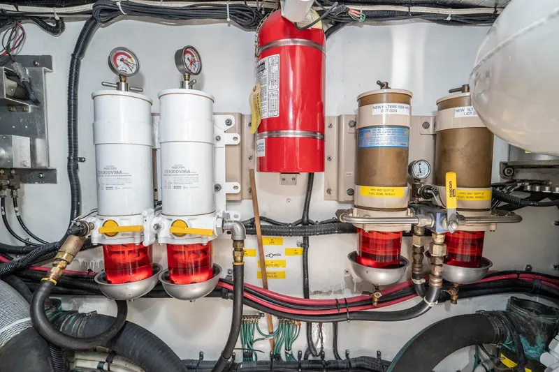 Slide: The Image of Engine room of a 1999 Sea Ray 500 Sundancer with fuel filters and fire extinguisher. - 41