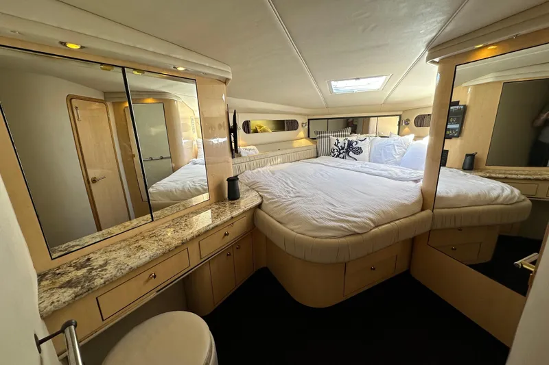 Slide: The Image of Luxurious 1999 Sea Ray 500 Sundancer yacht bedroom with elegant decor and spacious bed. - 5