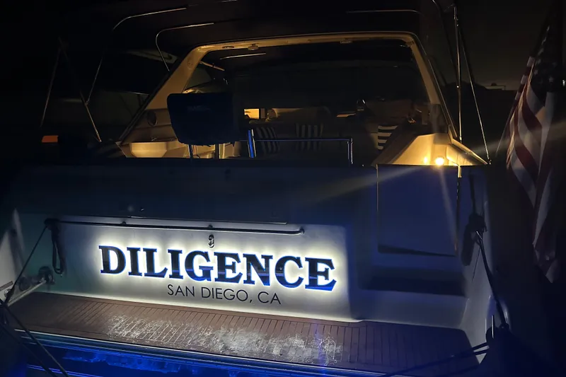 Slide: The Image of 1999 Sea Ray 500 Sundancer yacht named "Diligence" docked at night in San Diego, CA. - 7