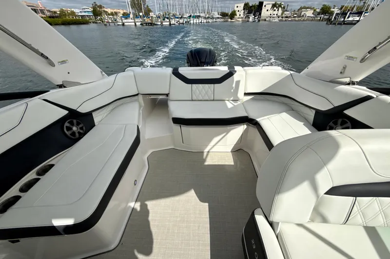 Slide: The Image of 2021 Regal 23 OBX boat interior with luxurious seating and waterfront view. - 10