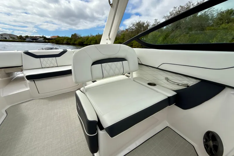 Slide: The Image of 2021 Regal 23 OBX boat interior with luxurious white seating and scenic water view. - 11