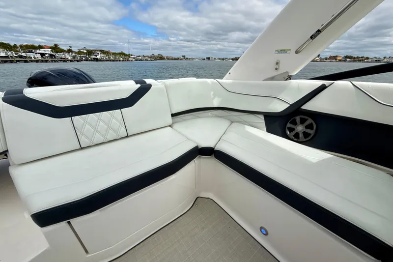 Slide: The Image of Luxurious seating on 2021 Regal 23 OBX boat with waterfront view. - 14