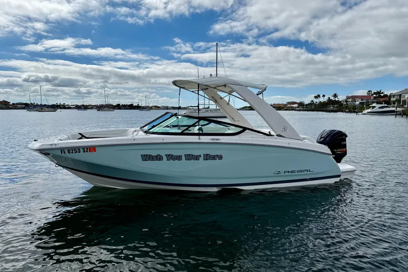 Slide: The Image of 2021 Regal 23 OBX boat on water, "Wish You Were Here" text on side. - 16