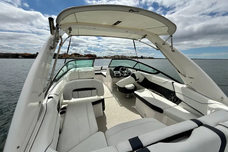 Slide: The Image of 2021 Regal 23 OBX boat interior with spacious seating and modern design on a sunny day. - 2