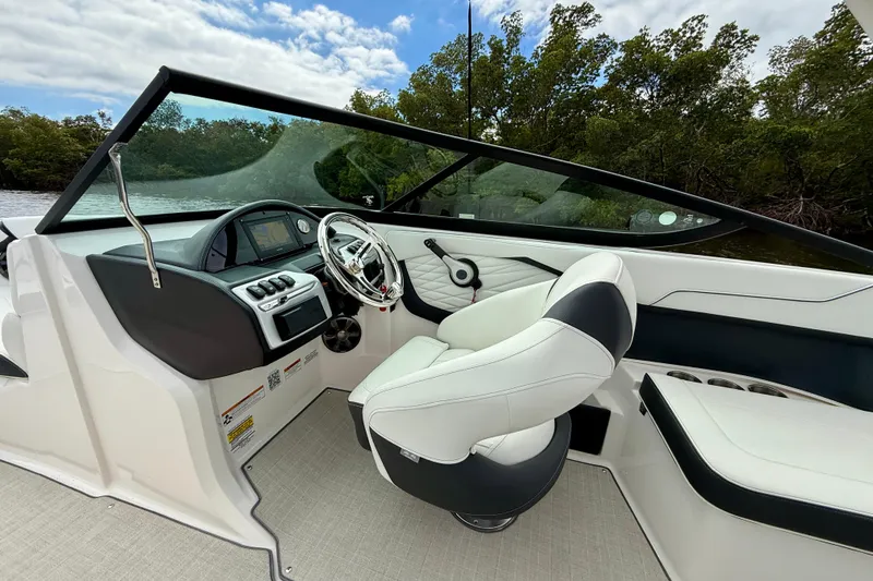 Slide: The Image of 2021 Regal 23 OBX boat interior with sleek dashboard and comfortable seating. - 4