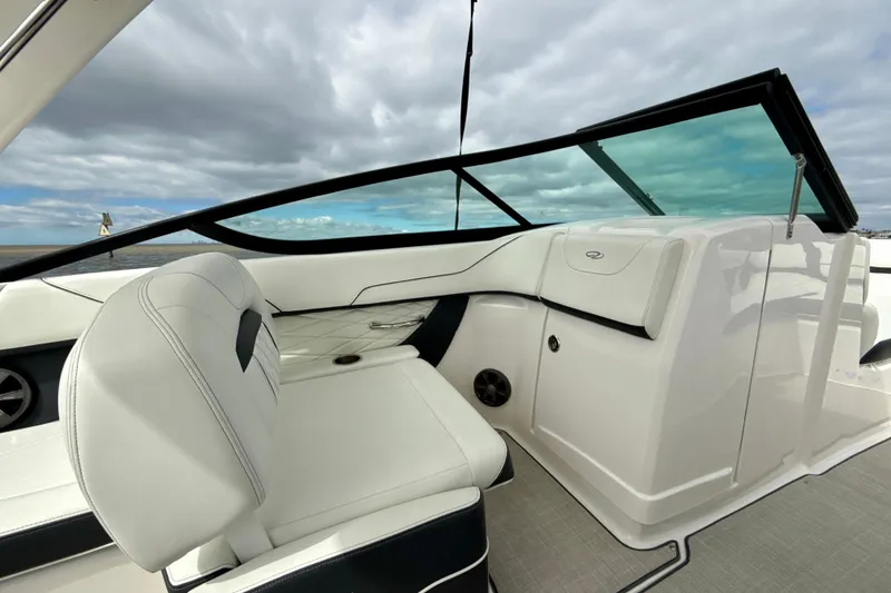 Slide: The Image of 2021 Regal 23 OBX boat interior with white seating and sleek dashboard design. - 5