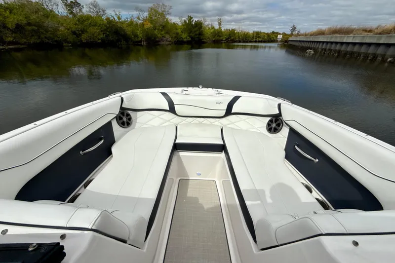 Slide: The Image of 2021 Regal 23 OBX boat interior with white seating and scenic water view. - 7