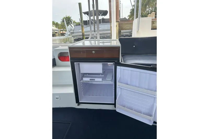 Slide: The Image of Open mini fridge on 2016 Duffy D-22 Bay Island boat, docked near water. - 4
