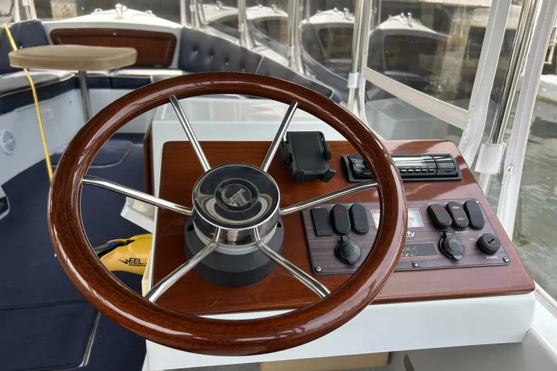 Slide: The Image of Steering wheel and controls of a 2016 Duffy D-22 Bay Island boat. - 6