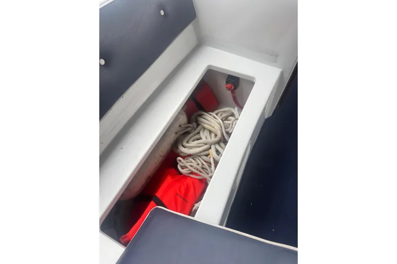 Slide: The Image of Storage compartment in 2016 Duffy D-22 Bay Island boat with rope and life jackets. - 10