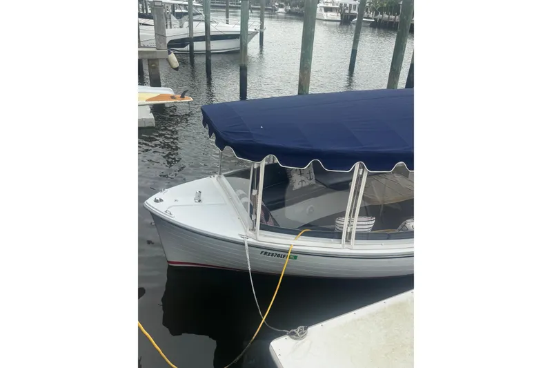Slide: The Image of 2016 Duffy D-22 Bay Island boat docked with blue canopy. - 3
