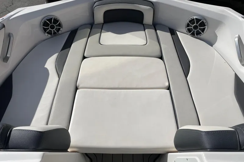 Slide: The Image of 2022 Yamaha Boats 195S interior with cushioned seating and built-in speakers. - 10