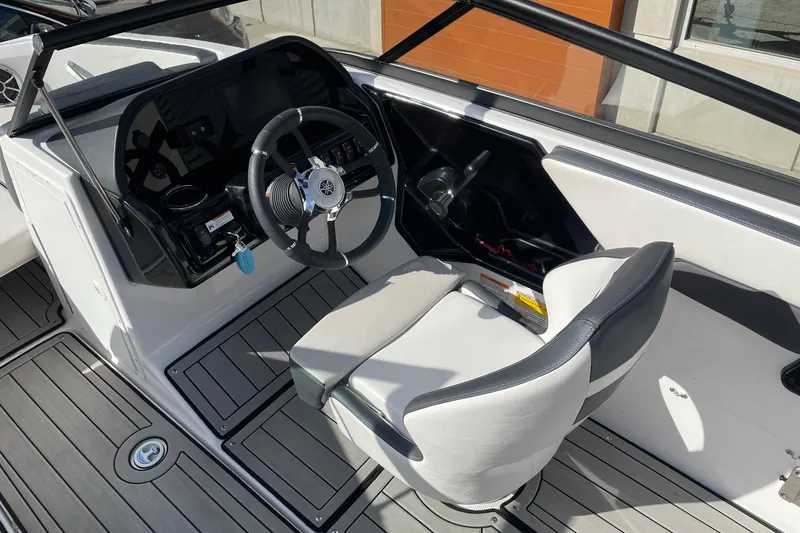 Slide: The Image of 2022 Yamaha Boats 195S cockpit with steering wheel and seating, featuring modern design. - 5