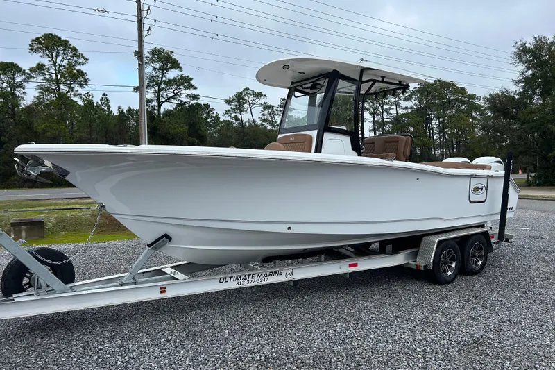 The Image of 2025 Sea Hunt Ultra 265 SE boat on trailer, parked outdoors. - 1