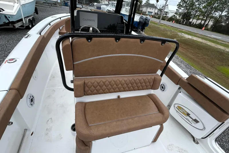 Slide: The Image of 2025 Sea Hunt Ultra 265 SE boat interior with brown cushioned seating and Garmin navigation. - 13