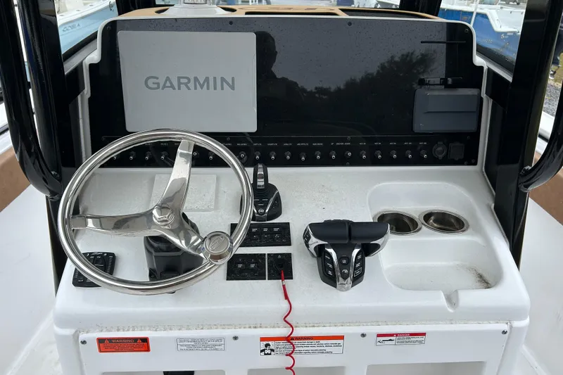 Slide: The Image of Steering console of 2025 Sea Hunt Ultra 265 SE with Garmin navigation system. - 14