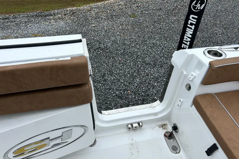 Slide: The Image of 2025 Sea Hunt Ultra 265 SE boat interior with brown seating and Ultimate logo. - 16